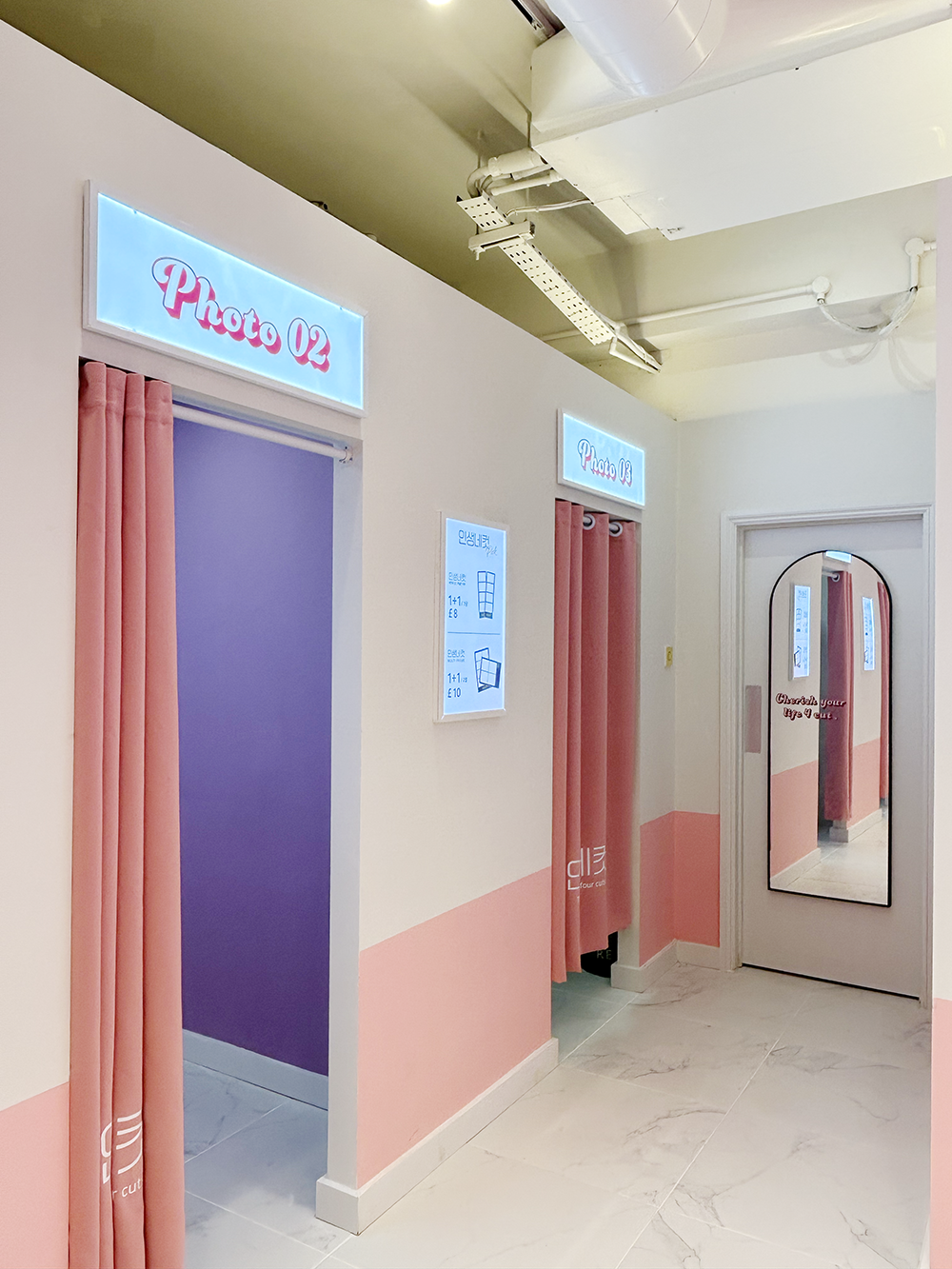 Photo booth entrance with pink curtains